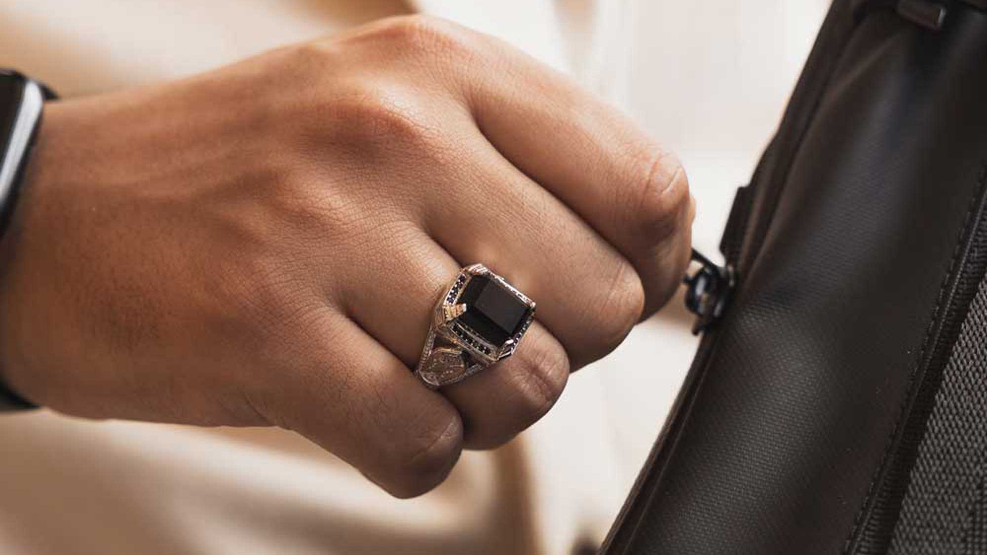 man wearing aqeeq black onyx stone ring on ring finger